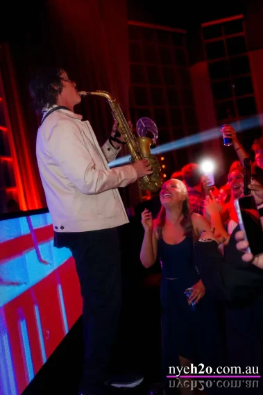 Live house saxophone player performing to party tracks at an upscale nye melbourne event on the Yarra