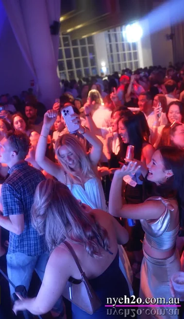 Group of women dancing together on the lively dance floor as they approach the midnight countdown