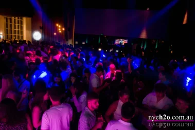 Packed crowd celebrating at the H2o Melbourne New Year's Eve event at Metropolis Southbank, with vibrant lighting, music, and a high-energy dance floor atmosphere