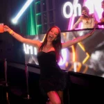 Woman celebrating and dancing on stage at a Melbourne new year eve party