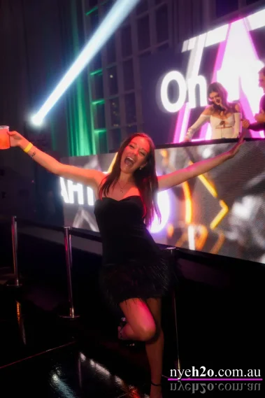 Woman celebrating and dancing on stage at a Melbourne new year eve party