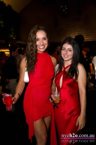 Dressed to impress, girls smiling and posing together at a waterfront new years eve event