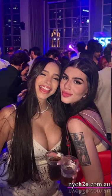 Elegant female friends dancing and laughing at a premium summer club night event in Melbourne